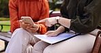 Business, closeup and women on a bench, smartphone or planning for collaboration, documents or discussion. Female professionals, freelancers or partners in a park, cellphone or mobile app for project