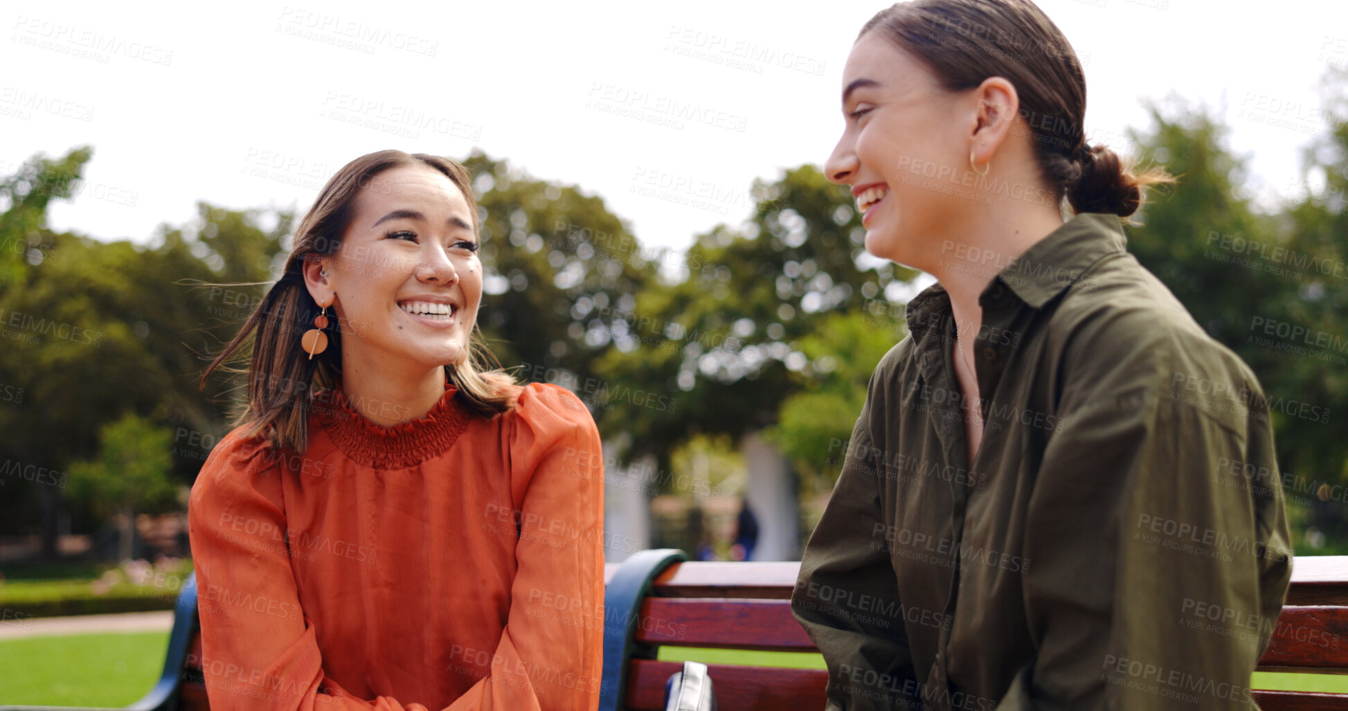 Buy stock photo Smile, friends and women at park bench, talking and communication outdoor. Conversation, relax and happy girls in nature together, listening to story or gossip, funny and laughing at comedy in garden