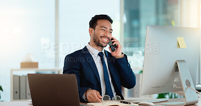 Buy stock photo Happy business man talking on his phone while working on a computer and smiling alone at work. Young corporate professional having a discussion and explaining project details to a colleague or client