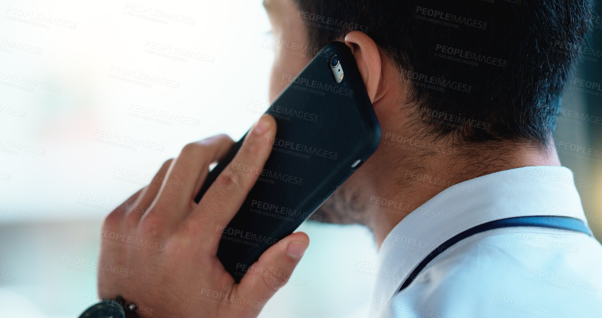 Buy stock photo Business man talking on a phone call in an office. Closeup of corporate professional and entrepreneur from the back networking to build a successful empire. Communicating plans and deals with clients