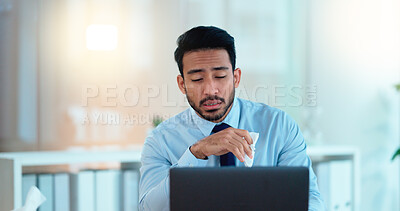 Buy stock photo A modern business man feeling sick with covid fatigue while working online at a desk on his laptop. Closeup of an male corporate manager blowing his nose. An ill office worker frustrated at work.