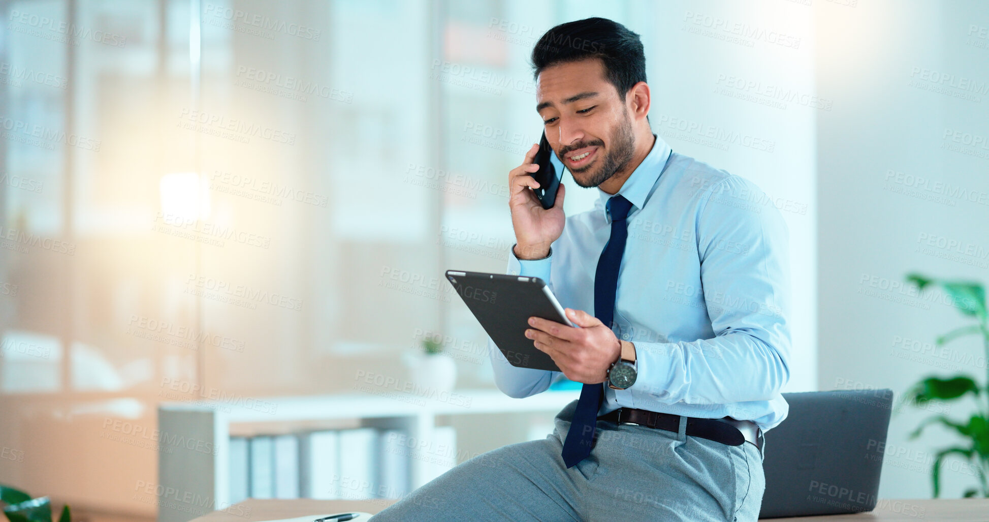 Buy stock photo Business man talking on a phone while browsing on a digital tablet in an office. Dedicated sales executive and young expert communicating project plans and discussing deals with clients in a company