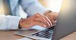 Lawyer sending emails on a laptop while working in a modern office. Closeup of advocate or legal assistant researching online. Searching for information while preparing for a case