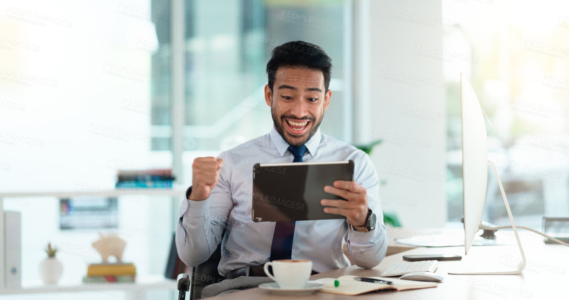 Successful and excited business man cheering with joy while