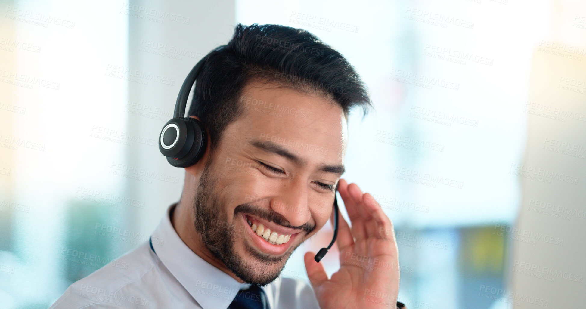 Buy stock photo Call center agent consulting a buyer via video call in an office. A young friendly sales man talking to a client in a virtual meeting. A male customer service employee advising a consumer