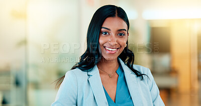 Successful female executive typing or reading an email. Confident business woman using a computer at work. Selective focus on beautiful lady sitting in an office chair, smiling.