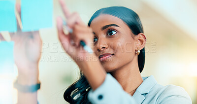 Buy stock photo A smart female entrepreneur planning the strategy of her company in the office. Young confident and successful business woman leader thinking and working on a project at the workplace