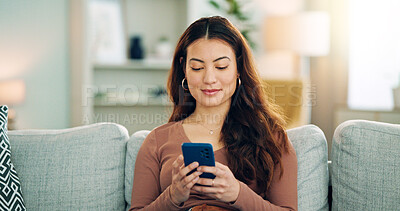 Phone, social media and happy woman texting on a dating app and smiling on the weekend at home on the couch. Smile, chatting and young girl loves typing a message on a social networking website