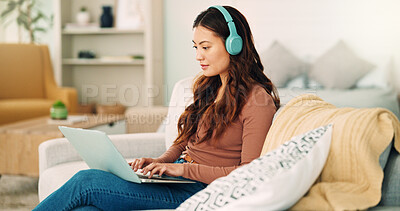Online work, internet music and woman listening to an audio podcast while typing an email on the living room sofa of house. Remote entrepreneur working on laptop with radio on the web on the couch