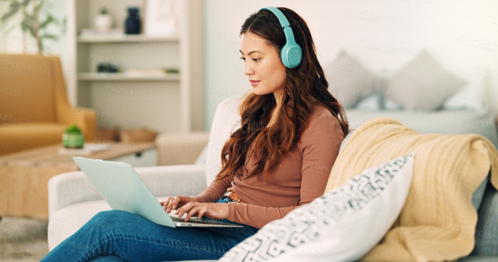 Buy stock photo Online work, internet music and woman listening to an audio podcast while typing an email on the living room sofa of house. Remote entrepreneur working on laptop with radio on the web on the couch