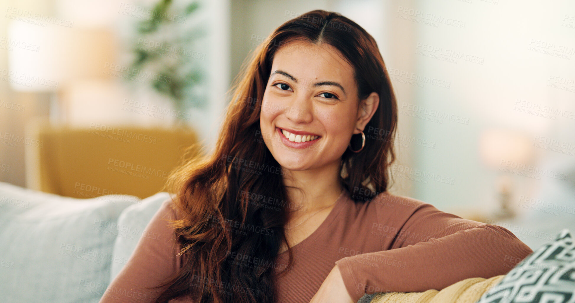 Buy stock photo Serious woman, relax and home with a beautiful asian female feeling calm, peaceful and enjoying her free time on the sofa at home. Portrait and face of a young female sitting in her singapore house