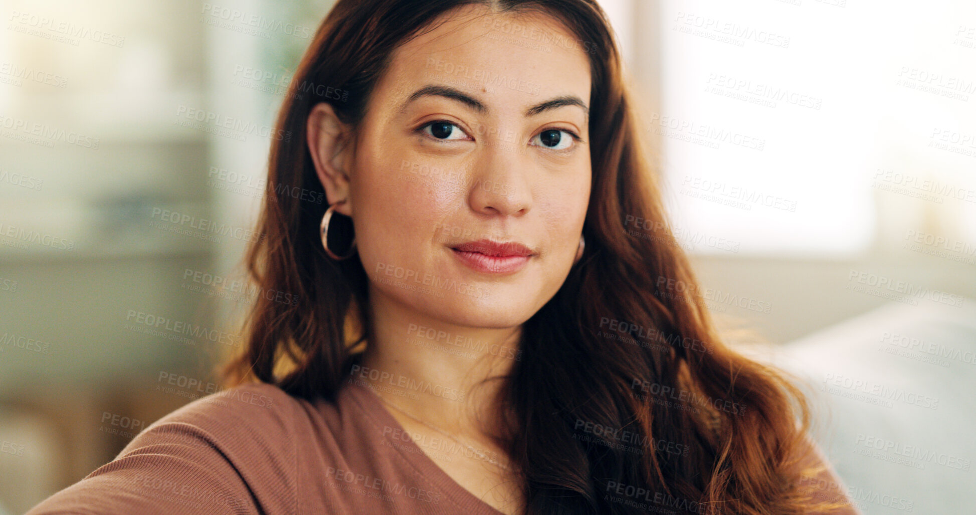 Buy stock photo Serious woman, relax and home with a beautiful asian female feeling calm, peaceful and enjoying her free time on the sofa at home. Portrait and face of a young female sitting in her singapore house