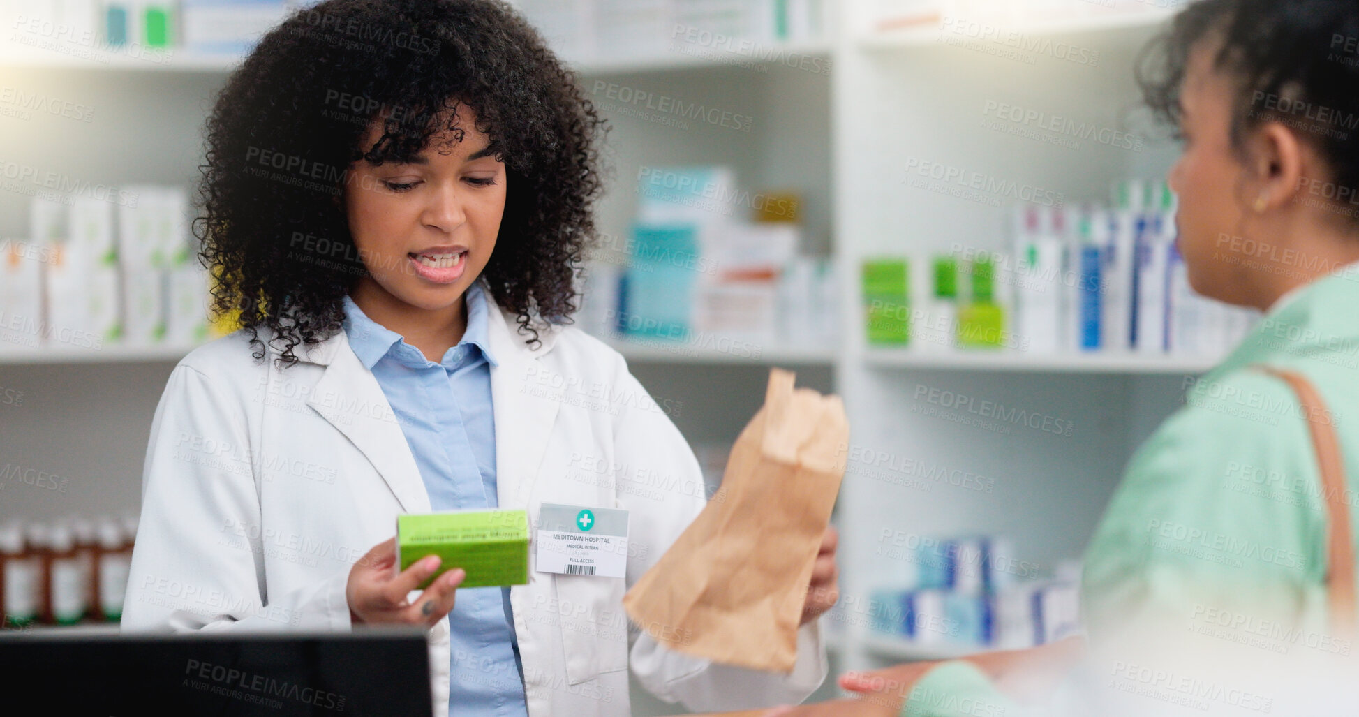 Buy stock photo Concerned pharmacist assisting an upset and angry customer in a local pharmacy. Female client returning medication and complaining about an allergic reaction after taking prescription medicine