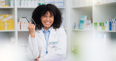 Buy stock photo A friendly female pharmacist with a bright smile is about to help patients at the dispensary. Portrait of happy woman healthcare professional smiling at the pharmacy. A doctor taking off her glasses
