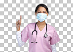 PNG cropped portrait of an attractive young female healthcare worker wearing a mask and pointing towards copyspace in studio against a grey background