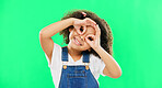 Green screen, happy and child with hands by eyes for glasses gesture for playing, happiness and fun. Emoji face, smile and portrait of girl with funny, comic and humour facial expression in studio