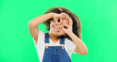 Buy stock photo Green screen, happy and child with hands by eyes for glasses gesture for playing, happiness and fun. Emoji face, smile and portrait of girl with funny, comic and humour facial expression in studio