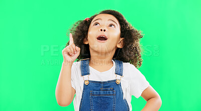 Buy stock photo Girl child, pointing up and green screen with idea, mockup space and cute with intelligent or clever choice. Mexican kid, face and smart with student advertising and hand sign in studio background 

