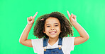 Mockup, green screen and child pointing up at product placement space isolated against a studio background. Excited, happy and portrait of young kid advertising and marketing showing deal or sale