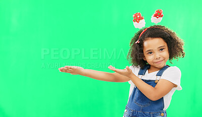 Product placement, green screen and portrait of a child doing a presentation on a studio background. Branding, mockup and girl kid showing a space for marketing, display or advertising on a backdrop