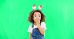 Shock, face and child in a studio with green screen with a wtf, omg or surprise facial expression. Christmas, festive and portrait of a girl kid with a xmas headband and wow gesture by chroma key.