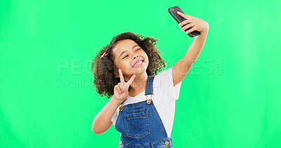 Buy stock photo Green screen, peace sign and girl with a smile, selfie and support on a studio background. Young person, child and kid with update, v hand and symbol with social media, post and profile picture