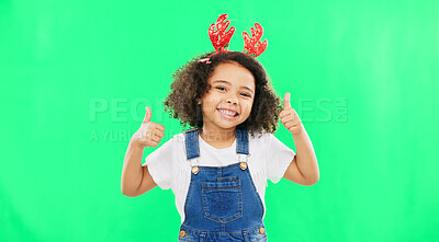 Buy stock photo Portrait, thumbs up and Christmas with a girl on a green screen background in reindeer horns for support. Smile, motivation and success with a happy young child on chromakey for festive celebration