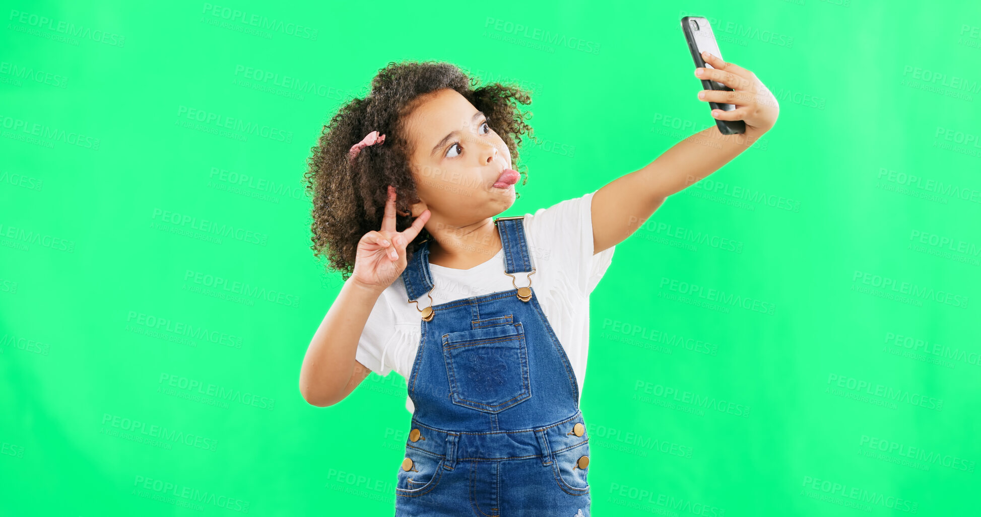 Buy stock photo Selfie, green screen or smartphone with girl, funny face or peace sign in studio, fashion or cute. Kid, comic or  style with cool, fun or creative with mockup, emoji or online for tech, cell or crazy