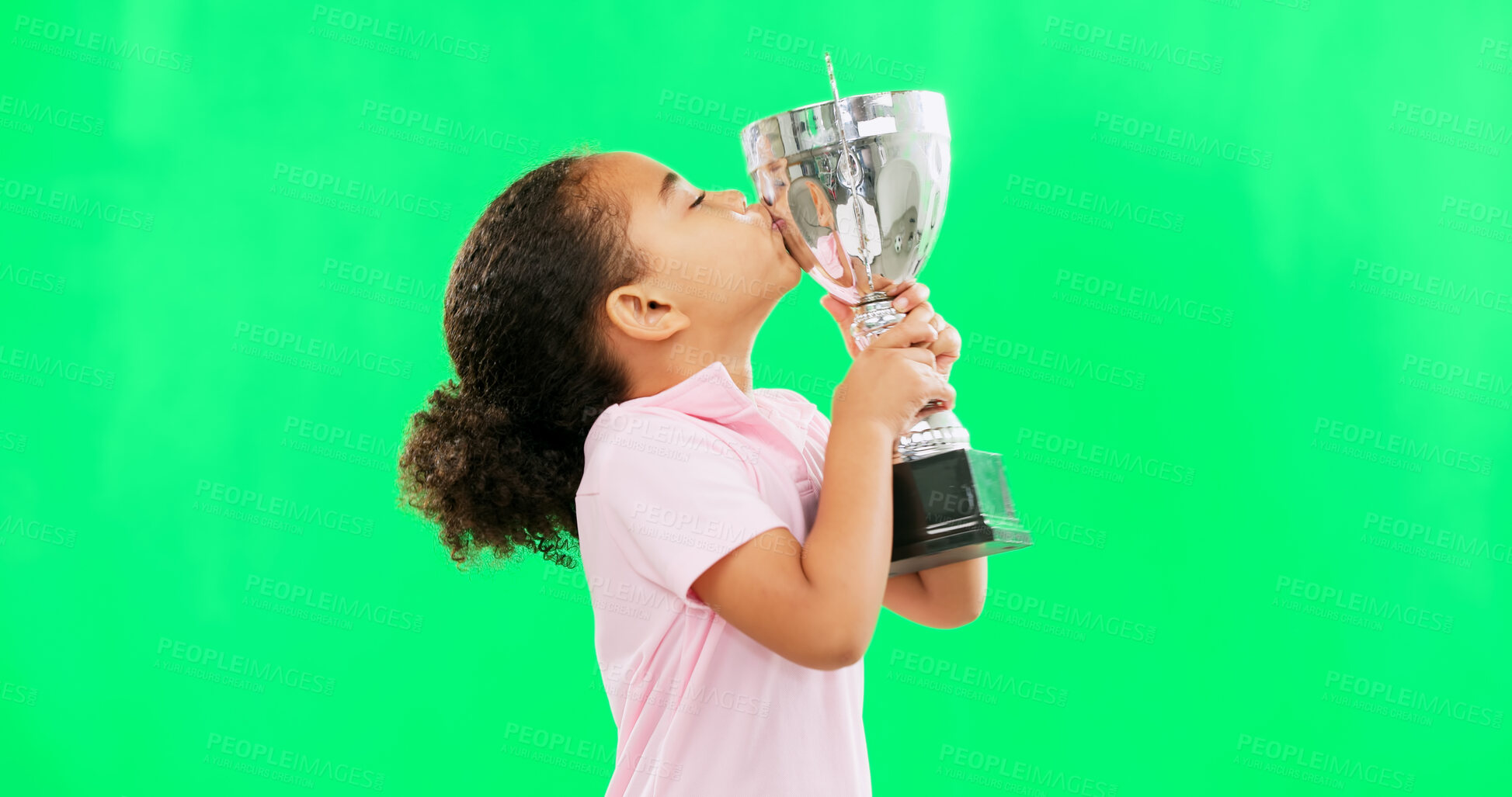 Buy stock photo Little girl, celebration and trophy kiss on green screen for winning, award or prize against a studio background. Female person, child or kid kissing achievement in sport championship on mockup space