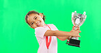 Happy, winning and face of child with a trophy isolated on a green screen studio background. Excited, success and portrait of a girl kissing an award for sports, achievement and champion with mockup