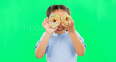 Donut on eyes, smile and child on green background with cake over face for funny, meme and comic. Food, excited kid and isolated happy girl with sweets, dessert treats and sugar doughnuts in studio