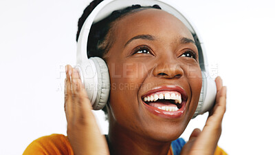 Happy, black woman and headphones for streaming music, excited and celebration against a studio background. African American female, lady and headset with happiness, audio and girl singing with song