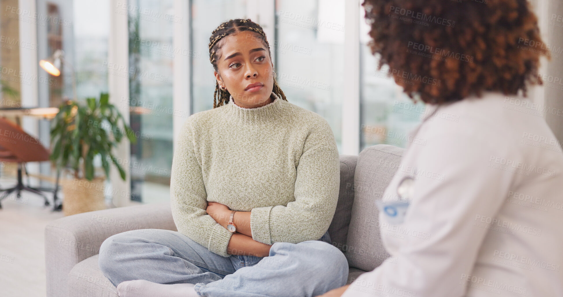 Buy stock photo Mental health, consulting and sad woman with doctor on sofa with conversation, help and support. Advice, psychology and therapist with patient on couch for depression counseling, care and therapy.