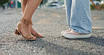 Feet, closeup and women in a road, shy and flirting while on their first date in a city. Shoes, lgbtq and lesbian couple sharing cute, romance and gay relationship, bonding and standing in a street