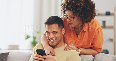 Social media joke, phone and happy couple on sofa with smile, laugh and internet meme in apartment. Happiness, man and woman on couch in living room, laughing and checking funny post online together.