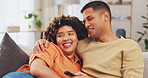 Film, love and entertainment with a couple watching tv on a sofa in the living room of their home together. Relax, video or television with a man and woman streaming series on a subscription service