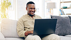 Laptop, sofa and happy black man typing in living room, working or social media in house. Freelancer, remote worker and person with computer on couch writing email, web research or browsing online.