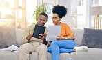 Tablet,documents, smile and couple on sofa in home living room, bonding and online shopping. Interracial, technology and happy black man and woman relax on social media, internet browsing or web scrolling.