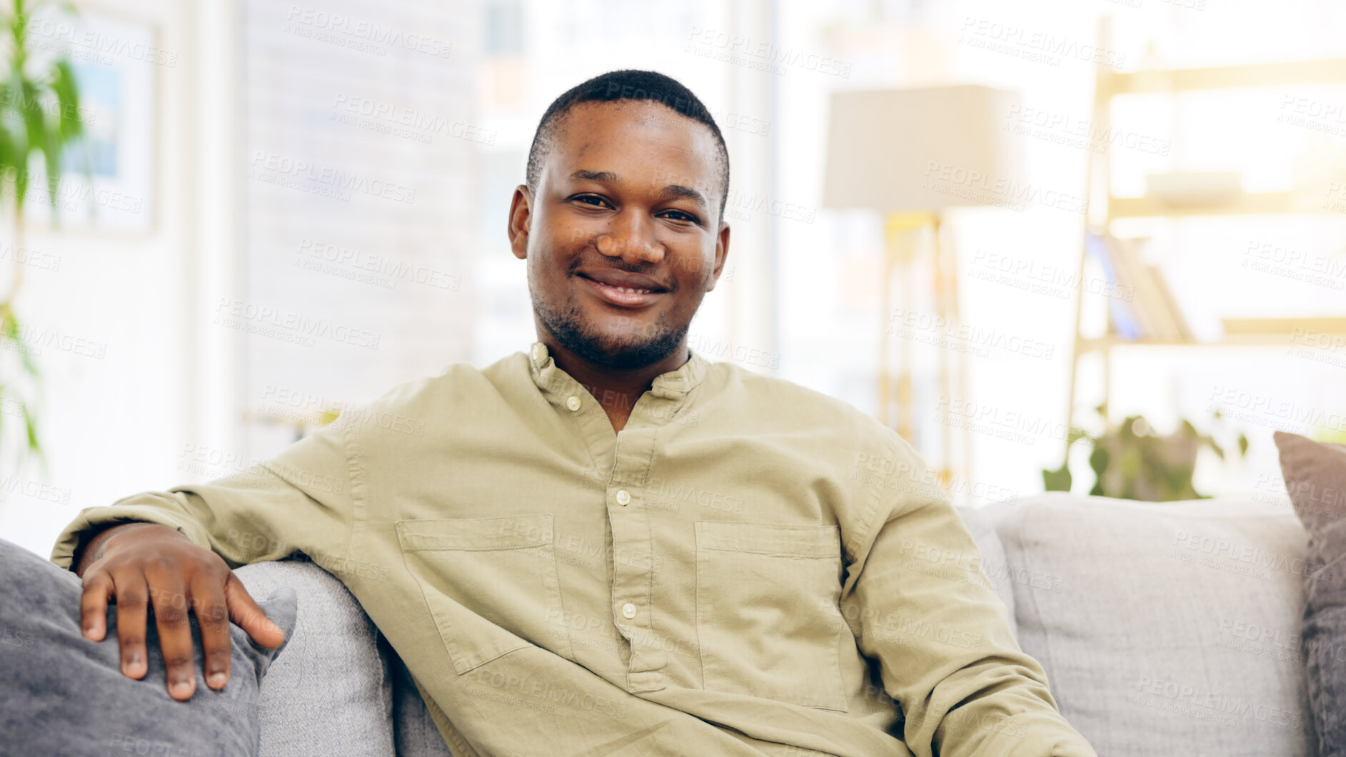 Buy stock photo Black man, relax and portrait on sofa in home on weekend, holiday and calm free time in apartment. Happy, face and smile on couch in house, living room or morning in lounge with peace and wellness