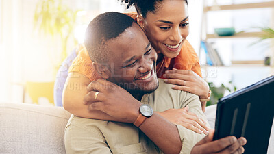 Buy stock photo Home, hug and couple with a tablet, social media and website information with communication, connection and network. Apartment, black man and happy woman with tech, internet or bonding with internet