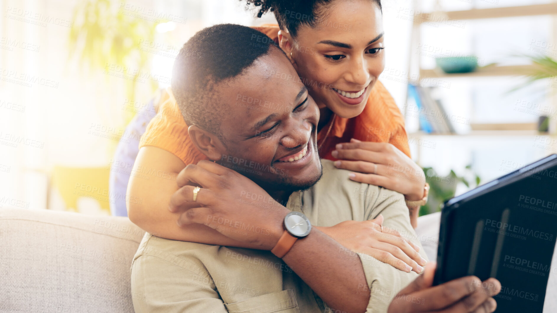 Buy stock photo Home, hug and couple with a tablet, social media and website information with communication, connection and network. Apartment, black man and happy woman with tech, internet or bonding with internet