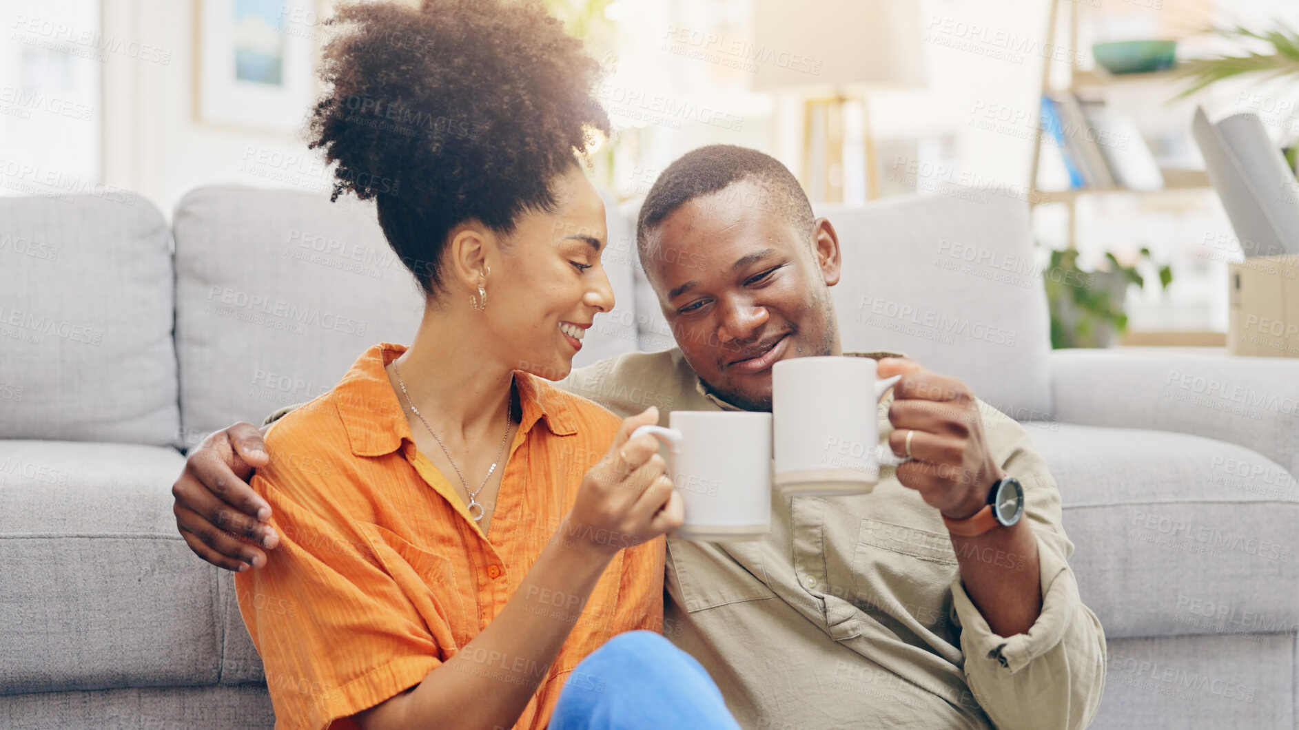 Buy stock photo Couple, smile and drinking coffee with hug to relax together, love and cheers for marriage. Happy people, diversity and trust or support in relationship, conversation and future planning on floor