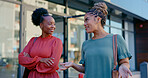 Black woman, friends and walking in city for communication, talking or socializing in the outdoors. Happy African American women discussing social life and friendship on sidewalk in an urban town