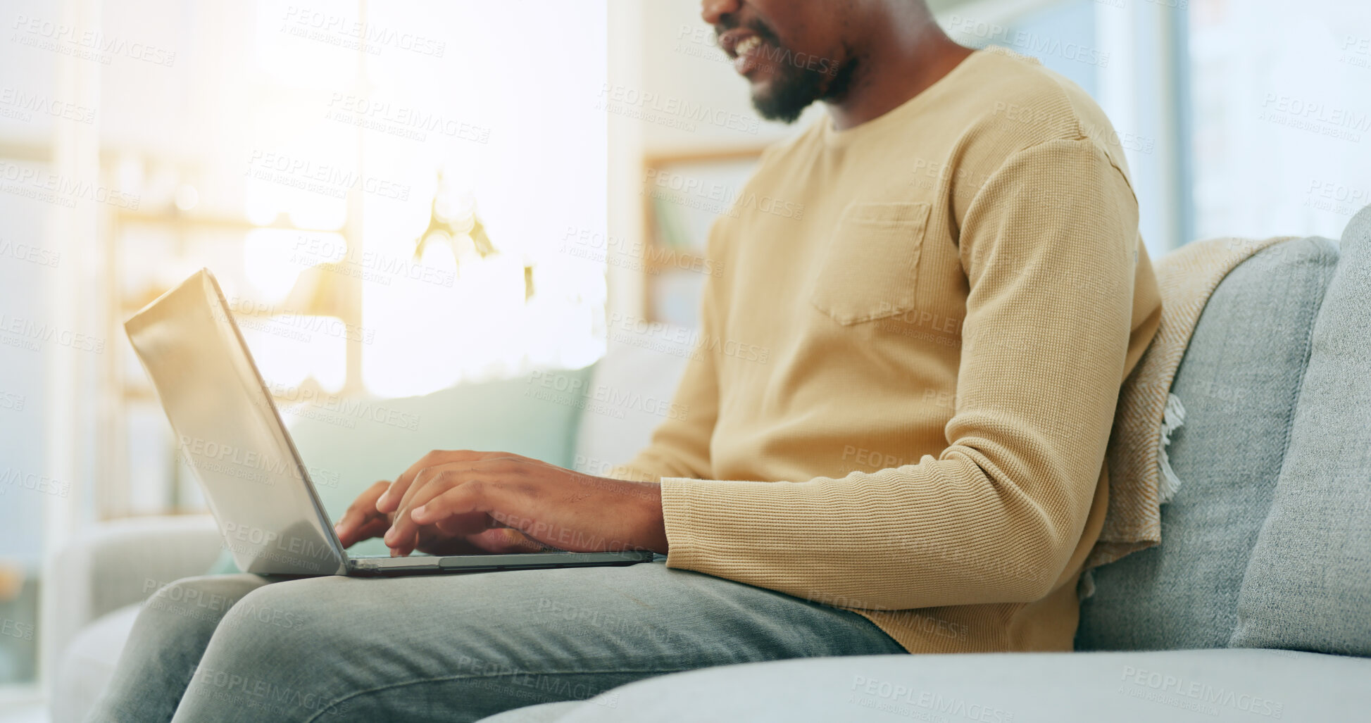 Buy stock photo Black man, typing and laptop on sofa for remote work from home with research, content creation or reading. African freelance employee, entrepreneur and computer with click, website and copywriting