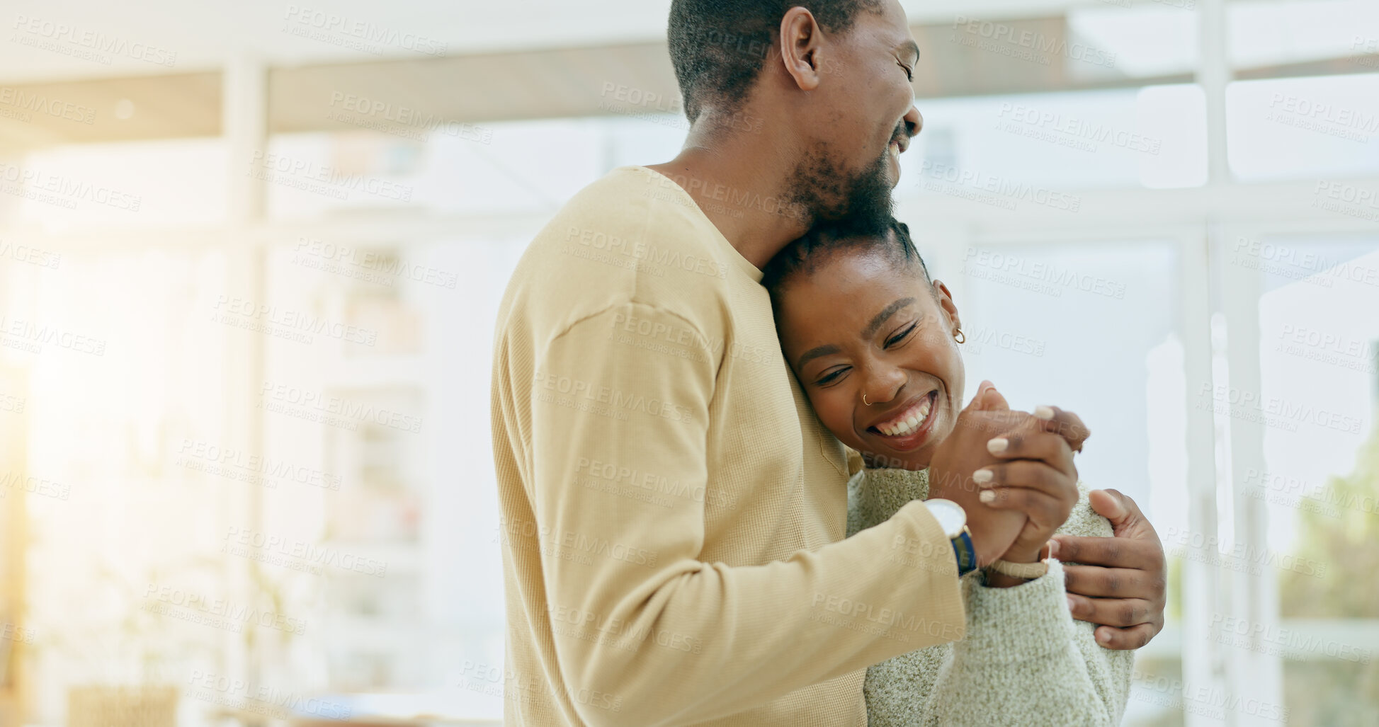 Buy stock photo Black couple, dance and hug in home together with love, care and bonding with music. Holding hands, man and woman dancing to relax with support, romance and trust connection or happy partnership