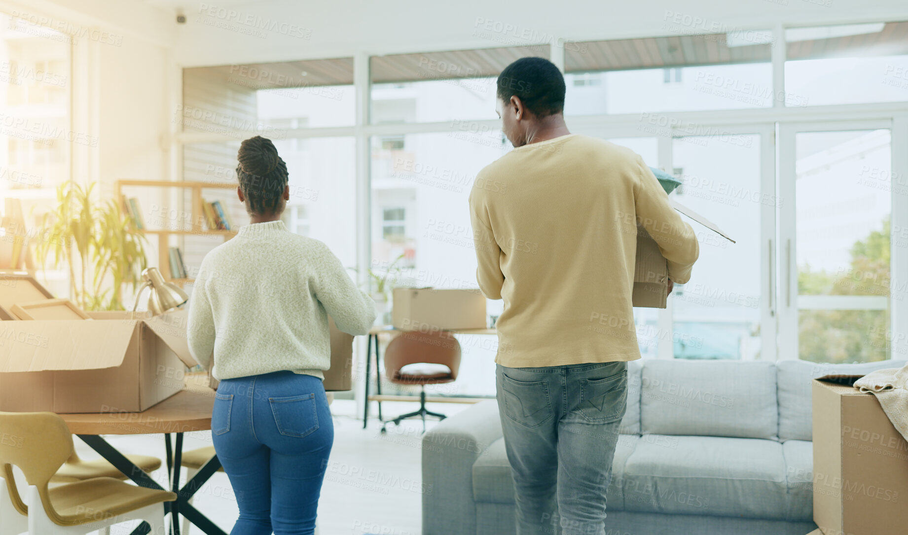 Buy stock photo Black couple, box and moving in new home, real estate or mortgage loan together in living room renovation. Rear view of African man and woman with boxes for property, house investment or apartment