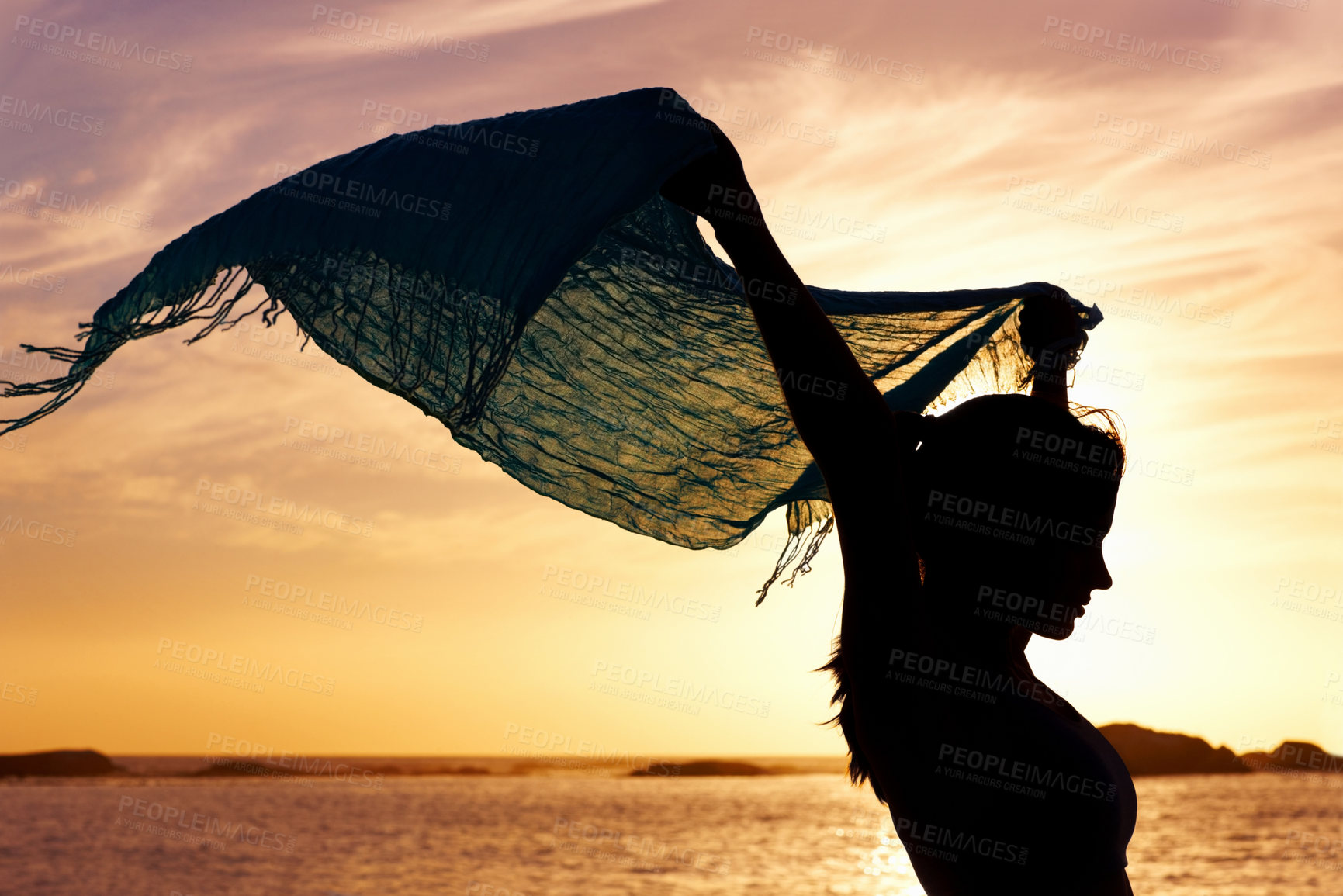 Buy stock photo Silhouette of a beautiful woman holding up shawl at sunset