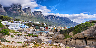 Buy stock photo Landscape view of mountains, sea and beach rocks in famous travel or tourism destination with residential houses. Scenic Twelve Apostles with blue sky and clouds in Camps Bay, Cape Town, South Africa