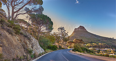 Buy stock photo An empty road on the mountain at sunrise. Street overlooking mountain peak with a scenic view of the city from a street on the mountain at sunset. The landscape of a beautiful view of Lions head 