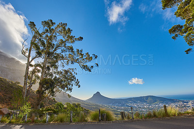 Buy stock photo Road or street leading to a scenic mountain view with blue sky during a summer roadtrip in Cape Town, South Africa. Landscape of lush green hills and a mountain pass for weekend exploring and driving